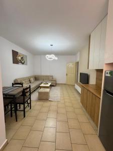 a living room with a couch and a table at Lushnja Central Elegance in Lushnjë