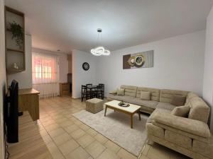 a living room with a couch and a table at Lushnja Central Elegance in Lushnjë