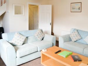 a living room with two couches and a coffee table at Cygnet Cottage - Uk43546 in Belford +7 photos