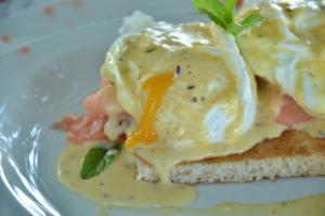 a white plate with an egg on top of a sandwich at Chundu Island in Victoria Falls