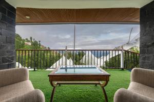 a room with a table and two chairs on a balcony at Splendid Retreat Hotels Kufri in Kūfrī