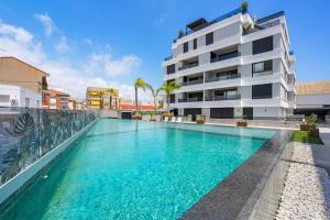 a swimming pool in front of a building at Pinatar Luxury in San Pedro del Pinatar