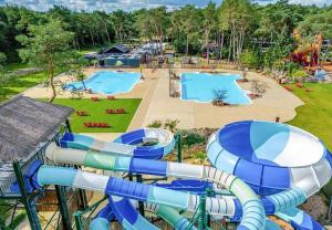 an aerial view of a water park with two slides at Cozy Chalet w terrace in the Middle of the Forest in Veluwe in Doornspijk