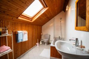 a bathroom with a sink and a toilet and a window at Chambres d'hôtes à Bavent in Bavent +35 photos