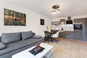 a living room with a couch and a kitchen at Schwarzwaldglück in St. Blasien