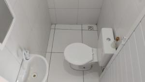 a white bathroom with a toilet and a sink at POUSADA BRISA do FUTURO in Fortaleza +28 photos