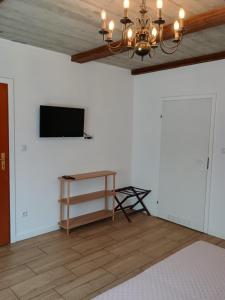 a living room with a television and a table at Pokoje u Ewy in Limanowa