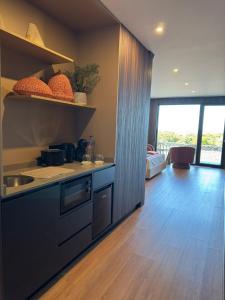 a kitchen with a sink and a counter top at RR Suites in São Mateus
