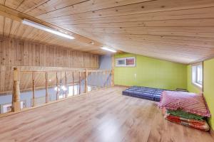 a room with a bed in the middle of a room at Suncheonman Muhan Dojan Pension in Suncheon