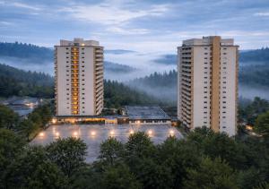 two tall buildings in a city with fog at Apartment Rehberg 14 OG Panorama Balkon Pool Sauna in Braunlage