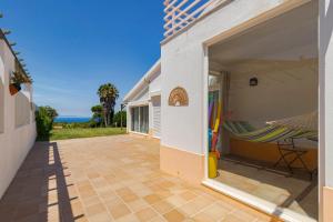 a patio with a hammock on the side of a building at Casa da Colina, By Home Match in Sesimbra
