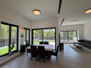 a living room with a table and chairs and a couch at וילה יובל in Yuval