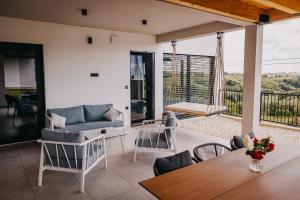 a living room with a couch and a table at Novak Home - Luxury villa with indoor pool & sauna in Štrigova