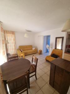 a living room with a table and a couch at Studio Prayssac in Prayssac