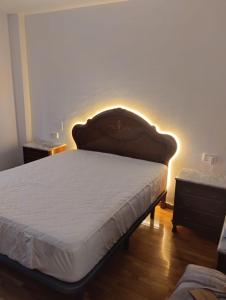 a bedroom with a bed with a light on the wall at Eclipse in Olvega