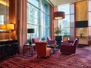 a lobby with chairs and a table and windows at HILTON Residence of LUXURY 5 STARS apartment F1 in Baku