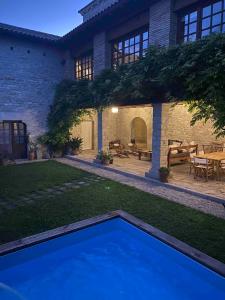 a backyard with a blue pool in front of a house at Etxauri Palace for art lovers in Echauri