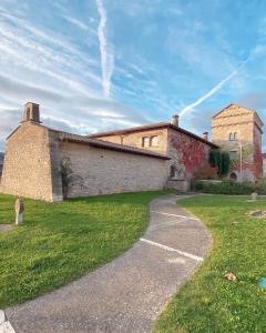a large brick building with a pathway in front of it at Etxauri Palace for art lovers in Echauri