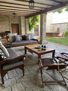 a patio with a couch and a table and chairs at Etxauri Palace for art lovers in Echauri +10 photos