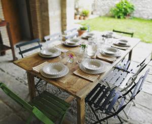 a wooden table with plates and dishes on it at Etxauri Palace for art lovers in Echauri