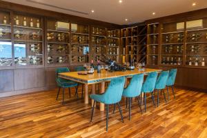 a dining room with a long table and blue chairs at Z Exquisite Koh Samui Domain with Infinity Pool in Nathon Bay