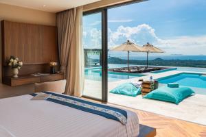 a hotel room with a bed and a swimming pool at Z Exquisite Koh Samui Domain with Infinity Pool in Nathon Bay
