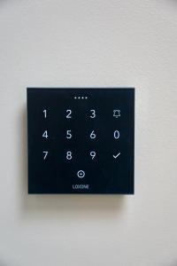 a close up of a black remote control on a wall at SmartStay in Gronau