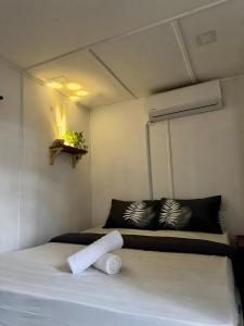 a small room with two beds in a room at Beach hut cabin in Marang