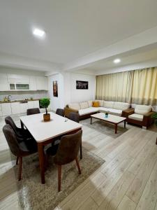 a living room with a table and a couch at Neptun Apartments in Gevgelija