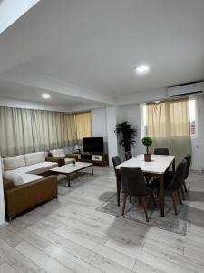 a living room with a couch and a table at Neptun Apartments in Gevgelija +3 photos