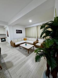 a living room with a couch and a table at Neptun Apartments in Gevgelija