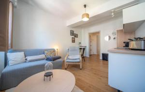 a living room with a couch and a table at Studio cosy - proche cathédrale in Chalon-sur-Saône