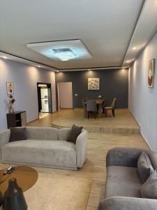 a living room with couches and a dining room at Campbell Residence Bouaké in Bouaké