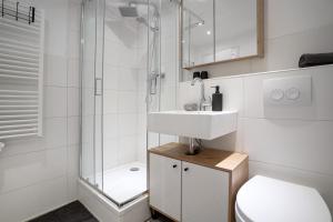 a bathroom with a sink and a shower and a toilet at Haus Biene am Meer in Norden +22 photos
