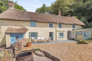 a large stone house with a thatched roof at 5 Bed in Bishops Lydeard oc-b45427 in  Liscombe