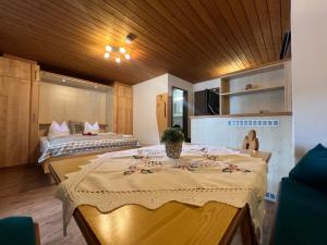 a room with two beds and a table in it at Petererhof in Gerlos +11 photos
