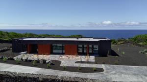 a black house with the ocean in the background at RR Suites in São Mateus +7 photos