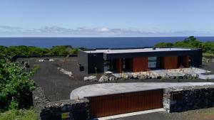 a house on a hill with the ocean in the background at RR Suites in São Mateus