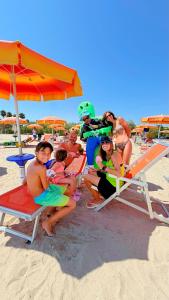 a group of people sitting on the beach at JuliaMare Village in Giulianova