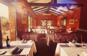 a restaurant with white tables and chairs and a room at Spa Complejo Rural Las Abiertas in San Bartolomé de las Abiertas +22 photos