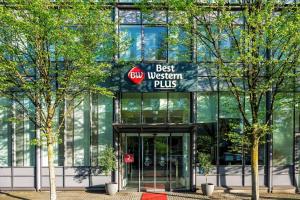 a building with a sign that reads best buy western plus at Best Western Plus Hotel Dresden City in Dresden