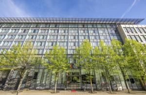 an office building with trees in front of it at Best Western Plus Hotel Dresden City in Dresden