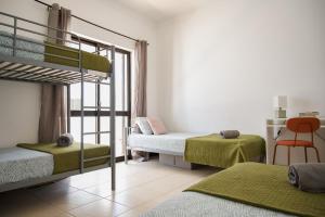 a bedroom with two bunk beds and a staircase at Fernando Pessoa Villa in Faro +21 photos