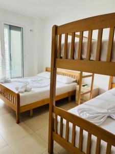 a bedroom with two bunk beds in a room at Apartament bisaku in Shëngjin