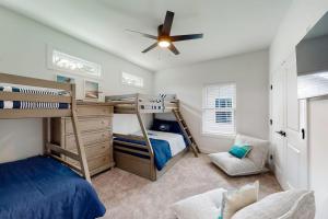 a bedroom with two bunk beds and a ceiling fan at Sapphire Sol in Ocean City
