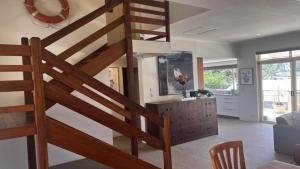 a wooden staircase in a living room with a kitchen at Ahoy Brunswick 1 in Brunswick Heads +14 photos