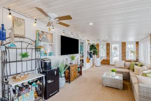 a living room with a couch and a ceiling fan at Montego Bay - Ocean 13336 in Ocean City