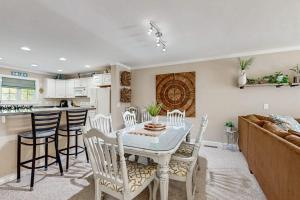 a dining room and kitchen with a table and chairs at B BY THE C in Ocean City