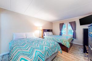 a hotel room with two beds and a television at White Marlin 303B in Ocean City