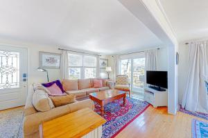a living room with a couch and a table at The Sea Captain's Sanctuary in Ocean City